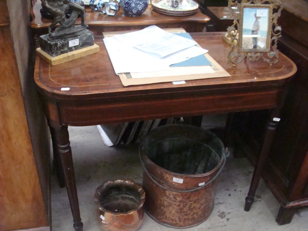 A 19th century mahogany fold-over top card table with string inlay and crossbanding