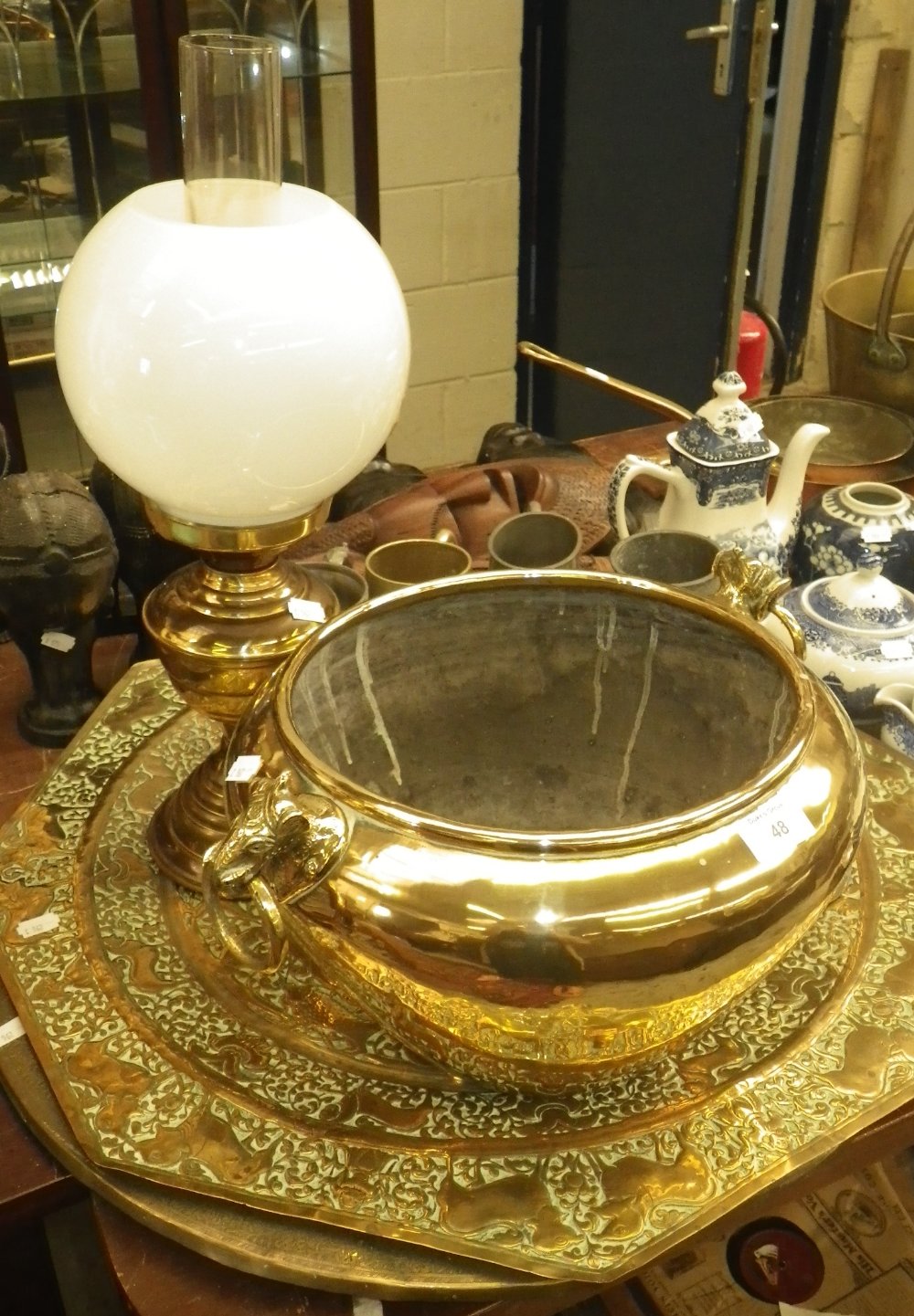 An Indian polished brass jardiniere, an octagonal brass tray and similar items of metalware