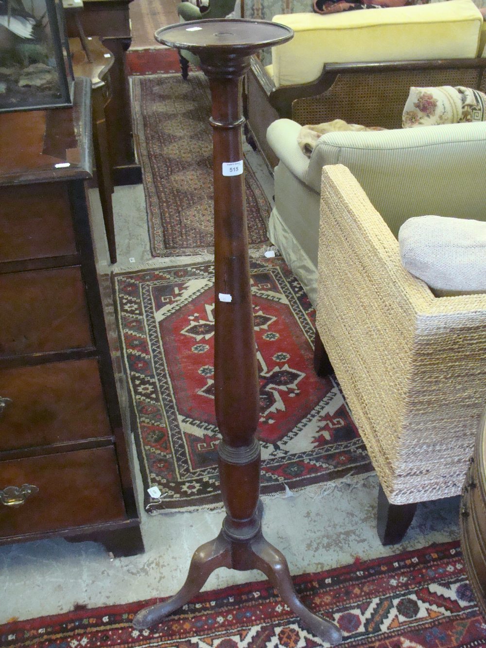 A mahogany torchère on tripod support