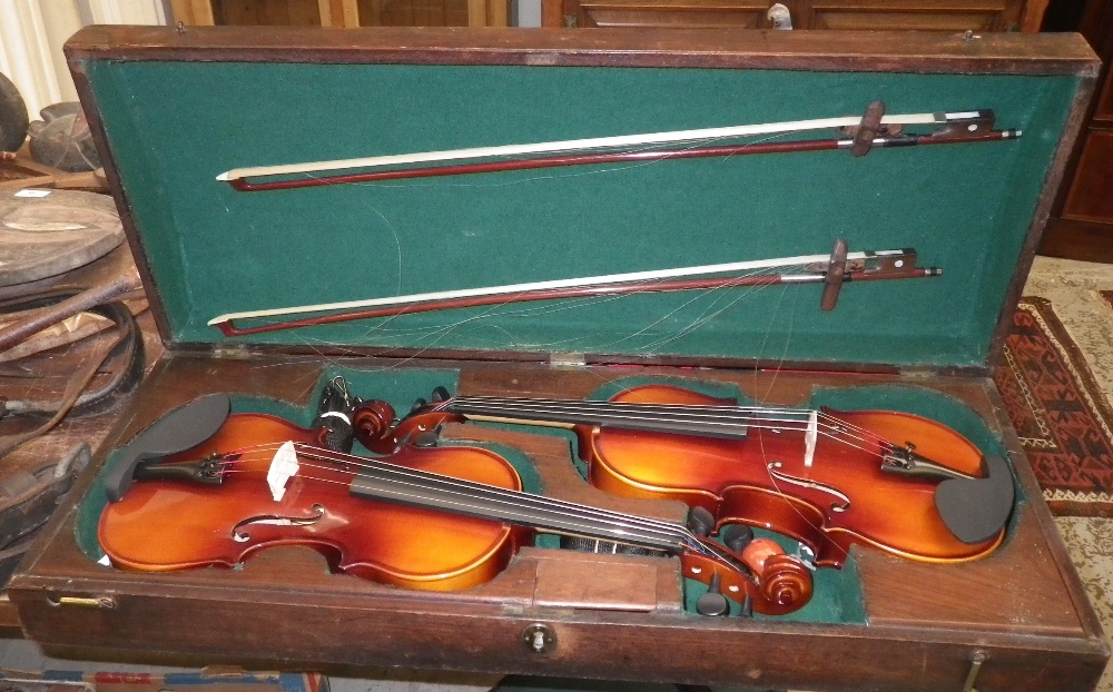 A George III mahogany domed case, containing two modern violins