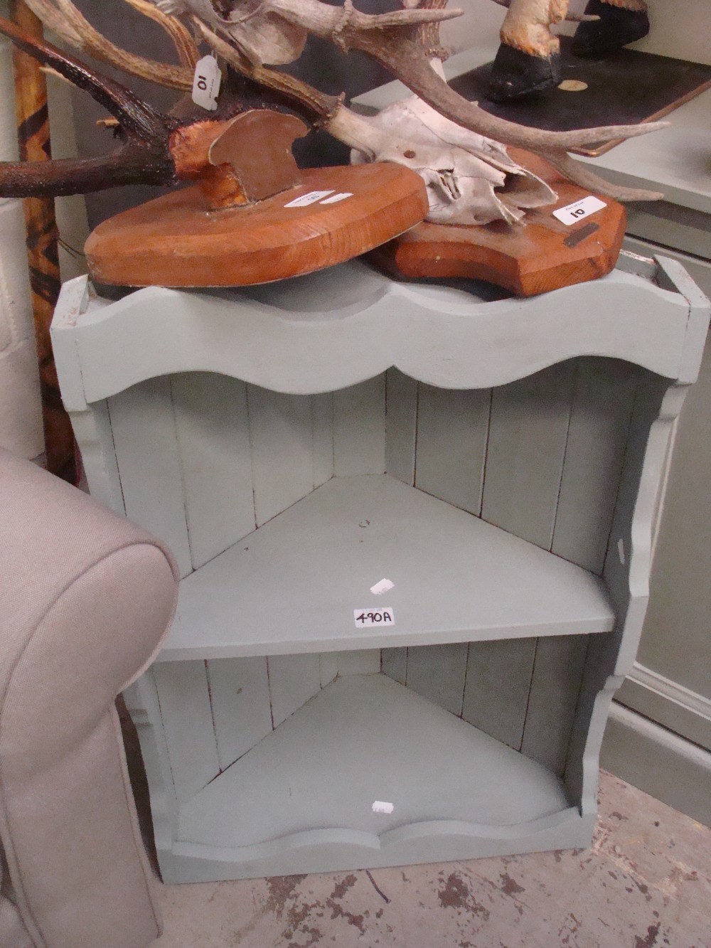 A pale green painted corner cabinet