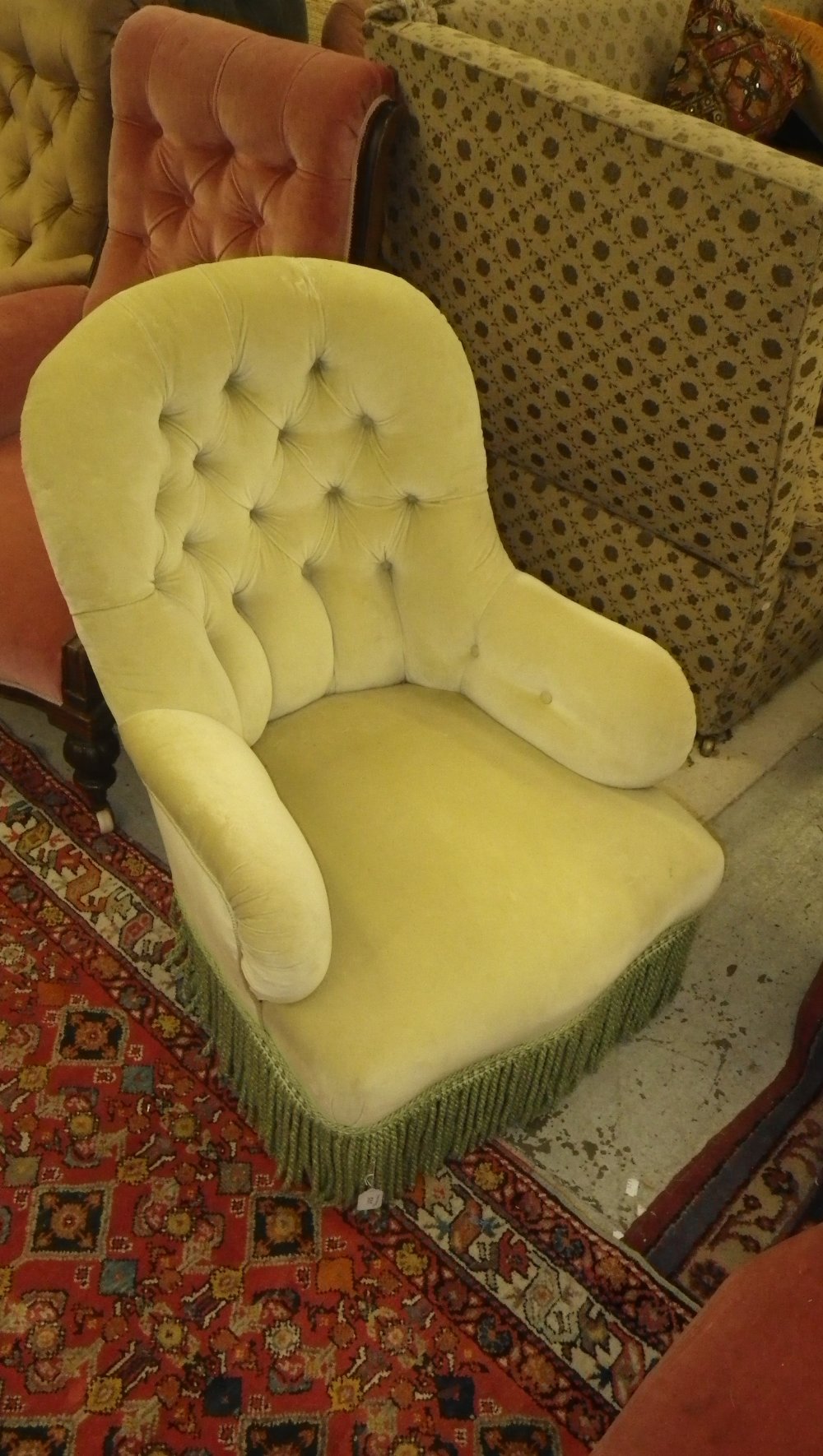 A Victorian tub chair with green velvet upholstery