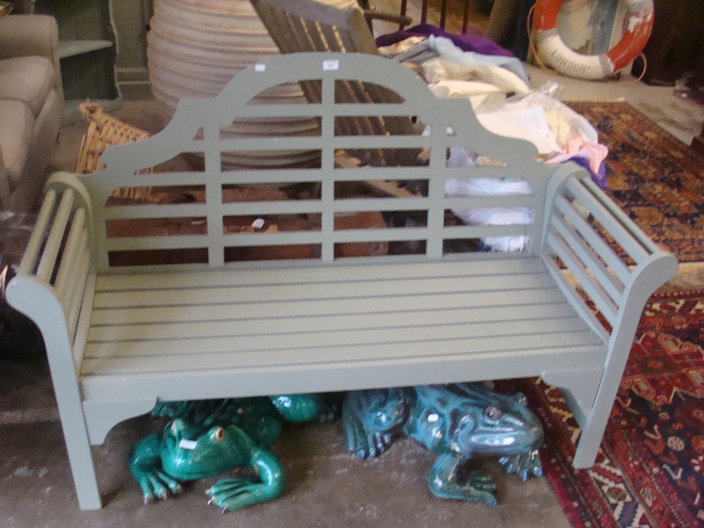 A Lutyens style garden bench, painted green