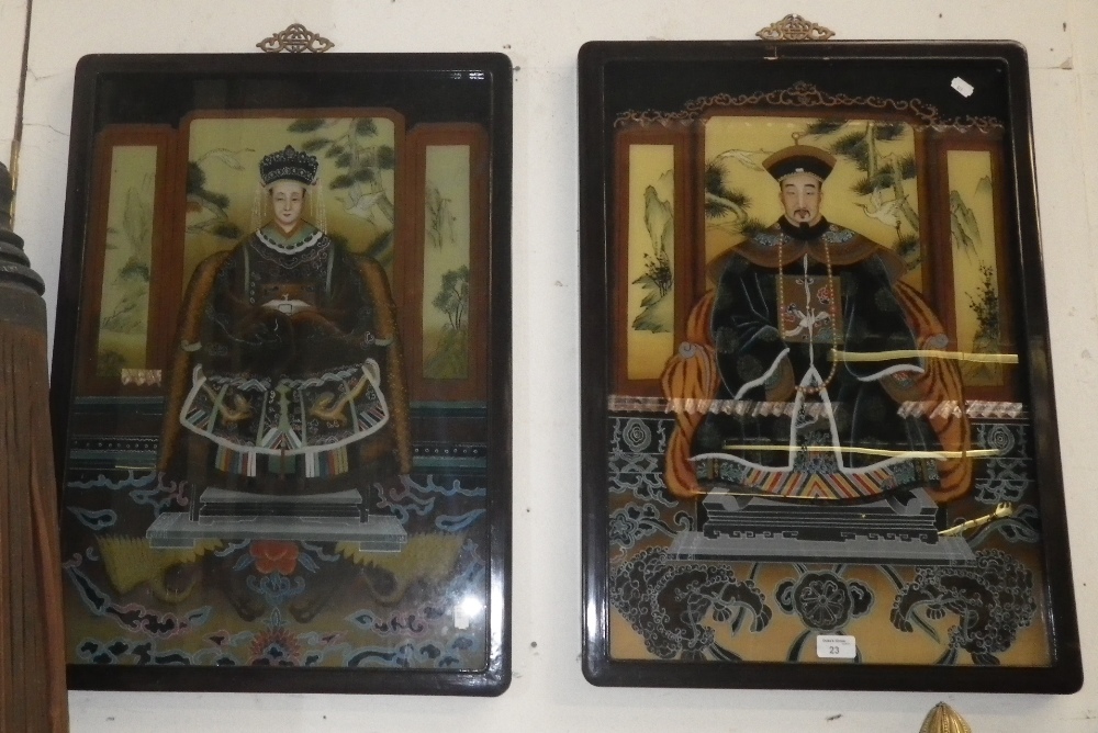 A pair of Chinese reverse painted glass panels, depicting dignitaries in lacquered frames