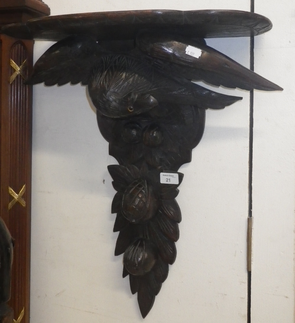 A large carved oak wall bracket, decorated with an eagle with glass eye