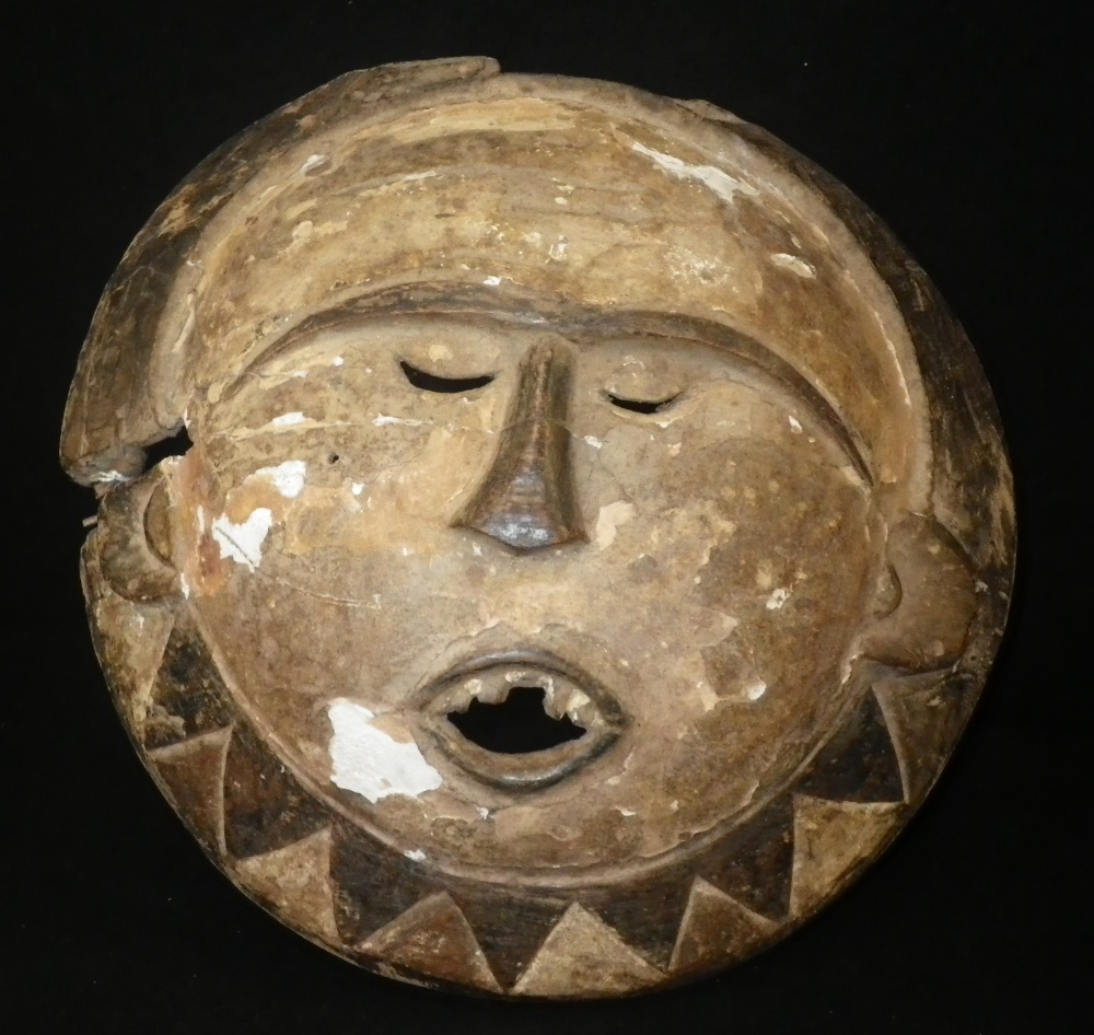 A Nigerian Eket painted mask of circular form, with radiating lower border, 13"" high