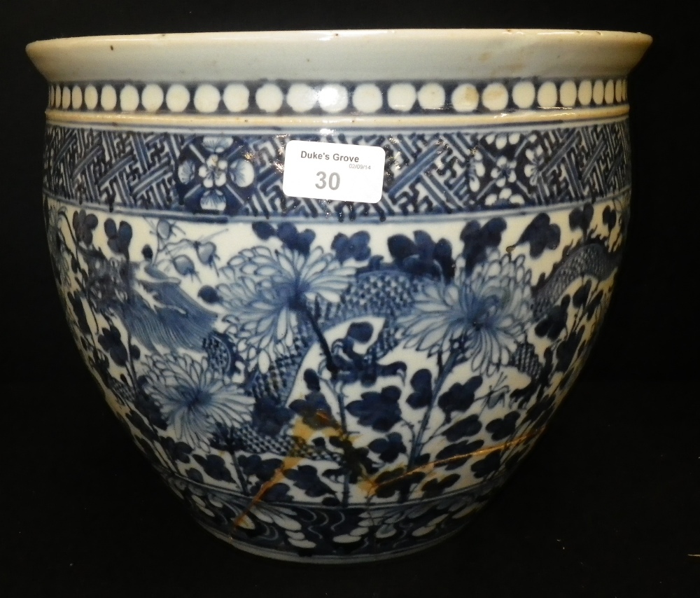 A blue and white oriental fish bowl, decorated with chrysanthemums