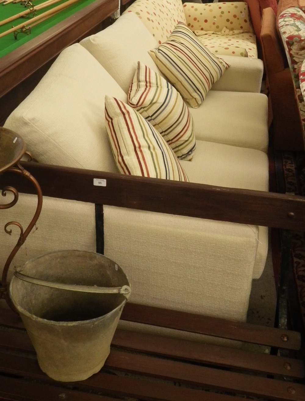A contemporary two seater bed settee upholstered in cream material.