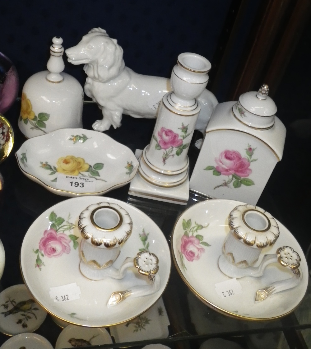 A pair of Meissen chambersticks with floral decoration and other similar items.