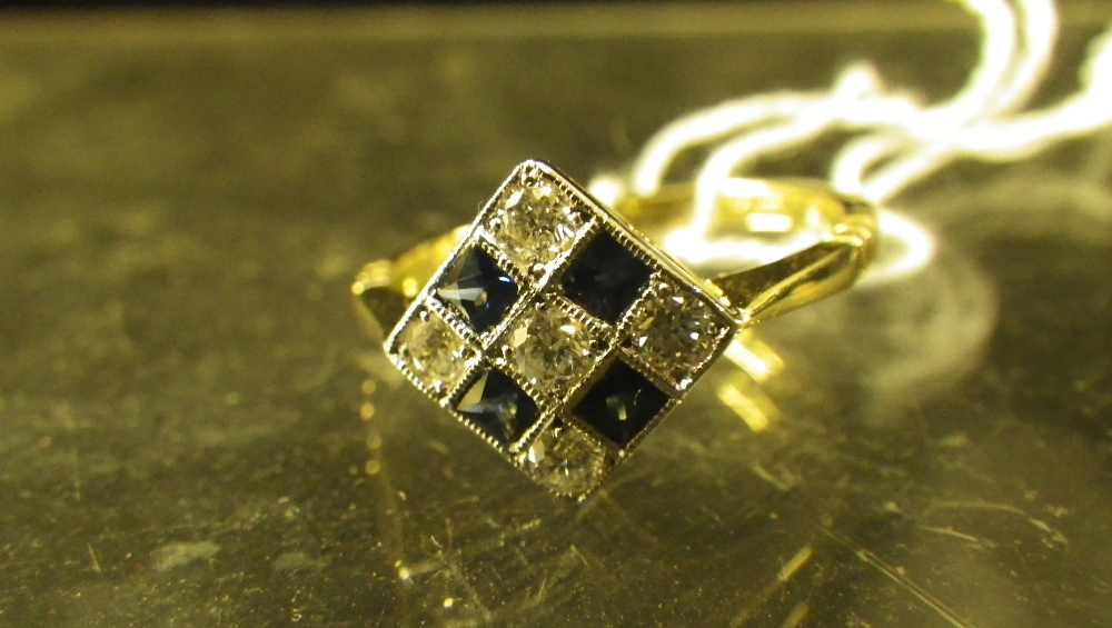 A sapphire and diamond square plaque ring in 18ct yellow gold.