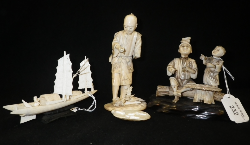 A Chinese carved ivory group of two figures seated by a table and other similar items.