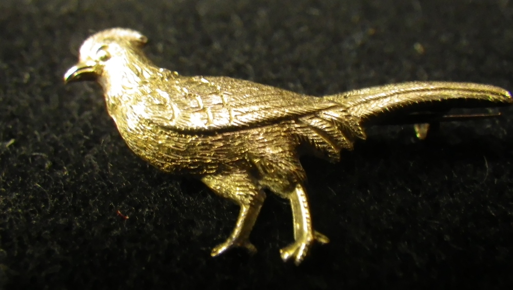 A 9ct yellow gold brooch modelled in the form of an exotic pheasant .