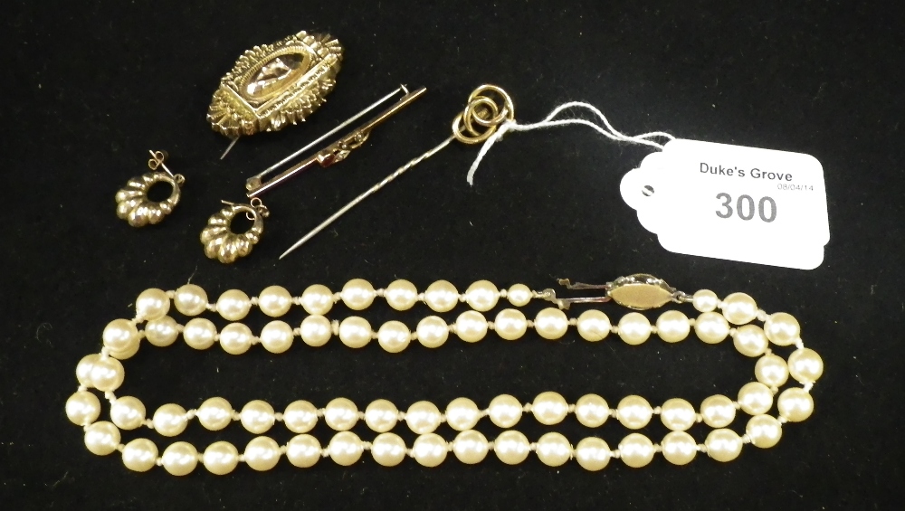 A collection of jewellery including a red stone and seed pearl bar brooch, a 9ct yellow gold