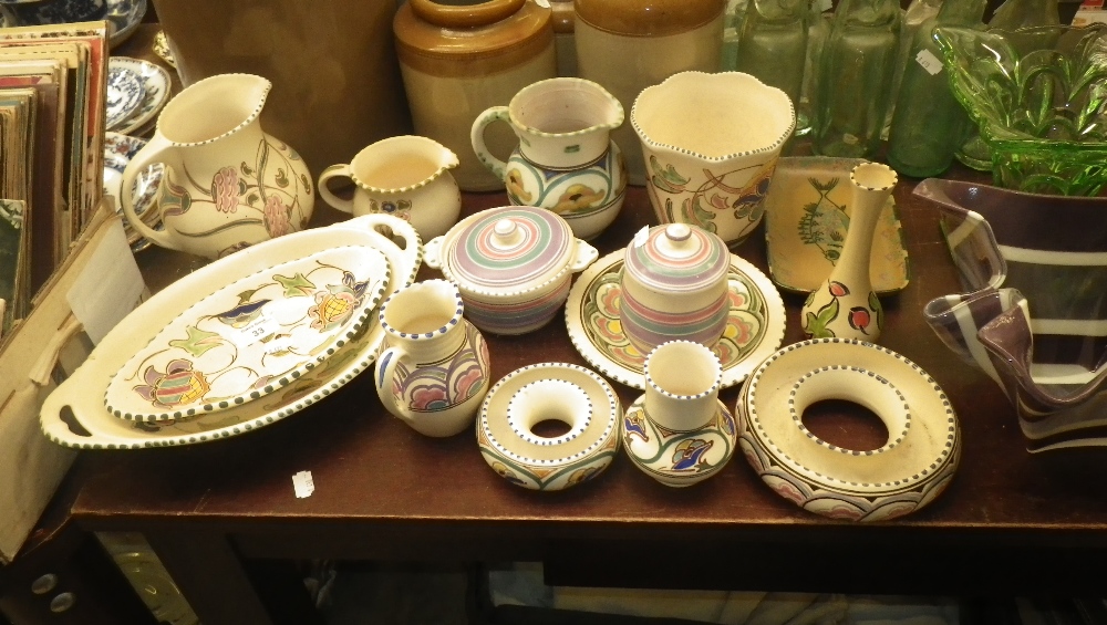 A hand painted Honiton pottery jug and a collection of similar Honiton pottery.