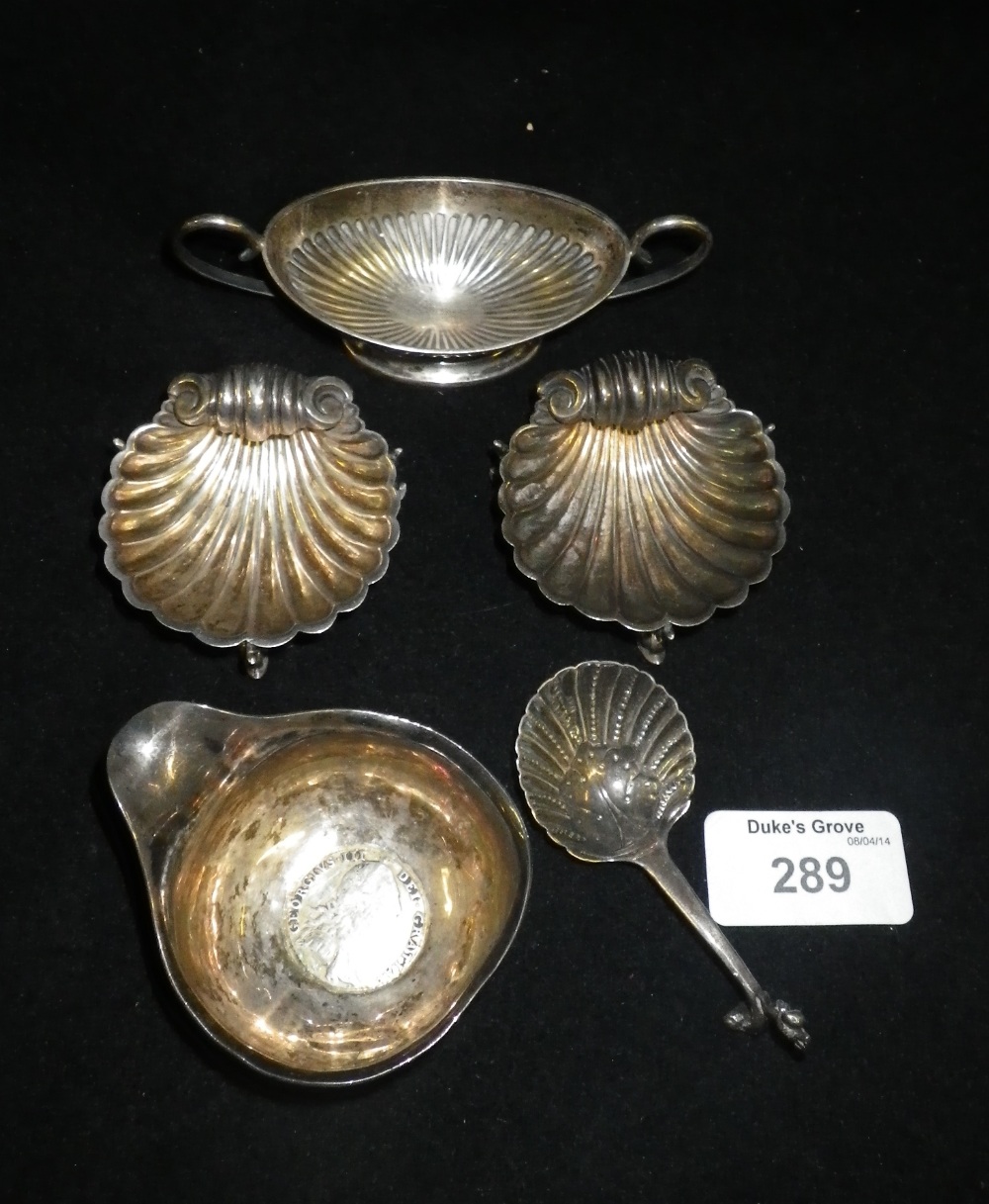 A pair of Victorian London silver salts in the form of scallop shells with dolphin feet and a