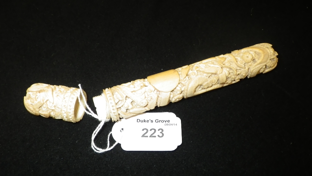 A carved ivory needle holder decorated with dragons.
