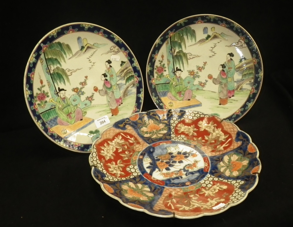 A Japanese Imari scalloped dish, decorated with flowers and two similar dishes.