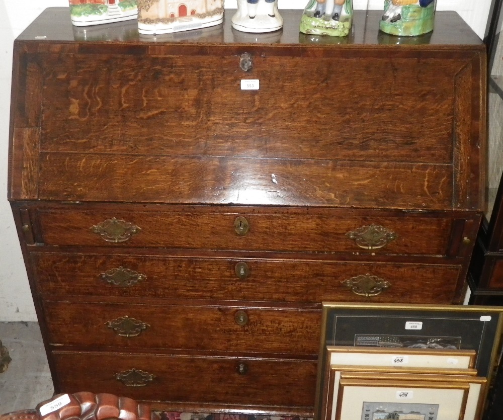 A George III oak and mahogany crossbanded bureau.