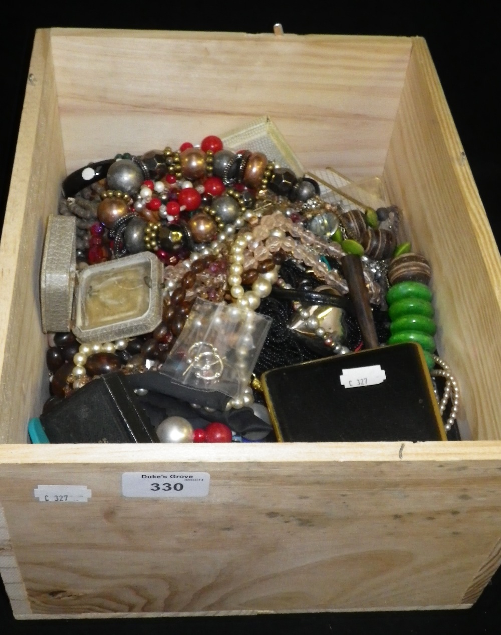 A large box of costume jewellery bead necklaces .