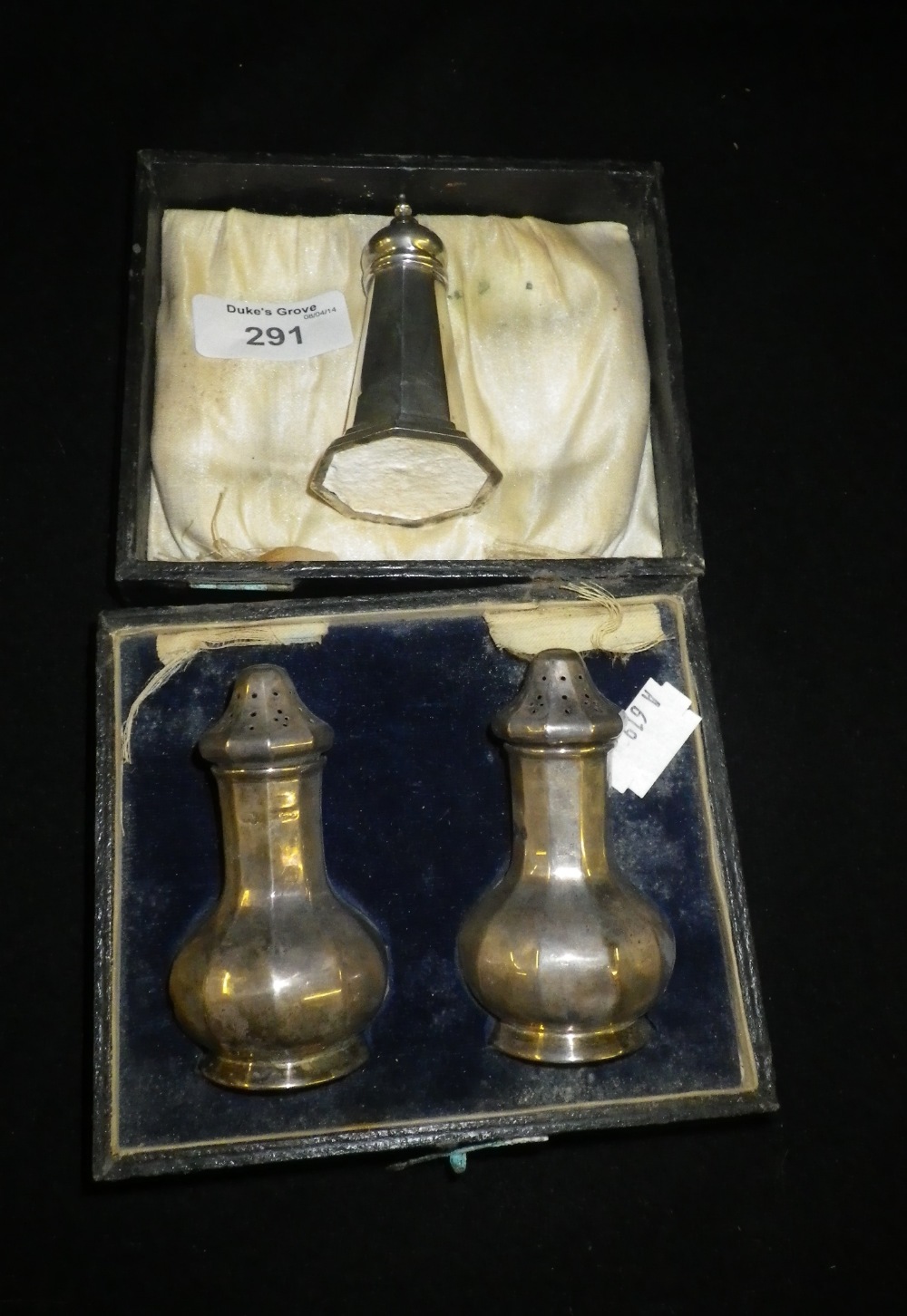 A faceted baluster-shaped silver salt and pepper castor set and a similar tapering silver castor (