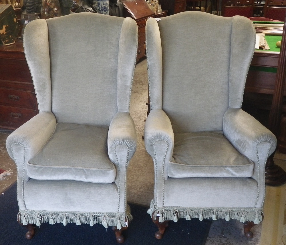 A pair of wing back armchairs on cabriole legs upholstered in duck-egg blue Draylon with matching