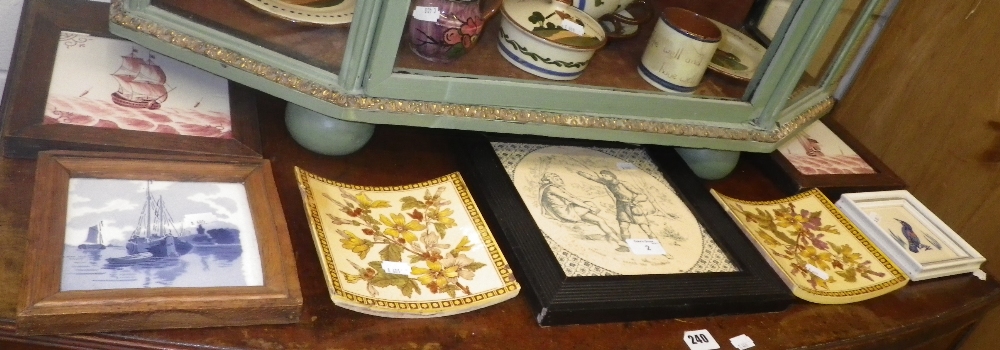 A Poole pottery tile depicting a bird and a collection of similar tiles (some framed).