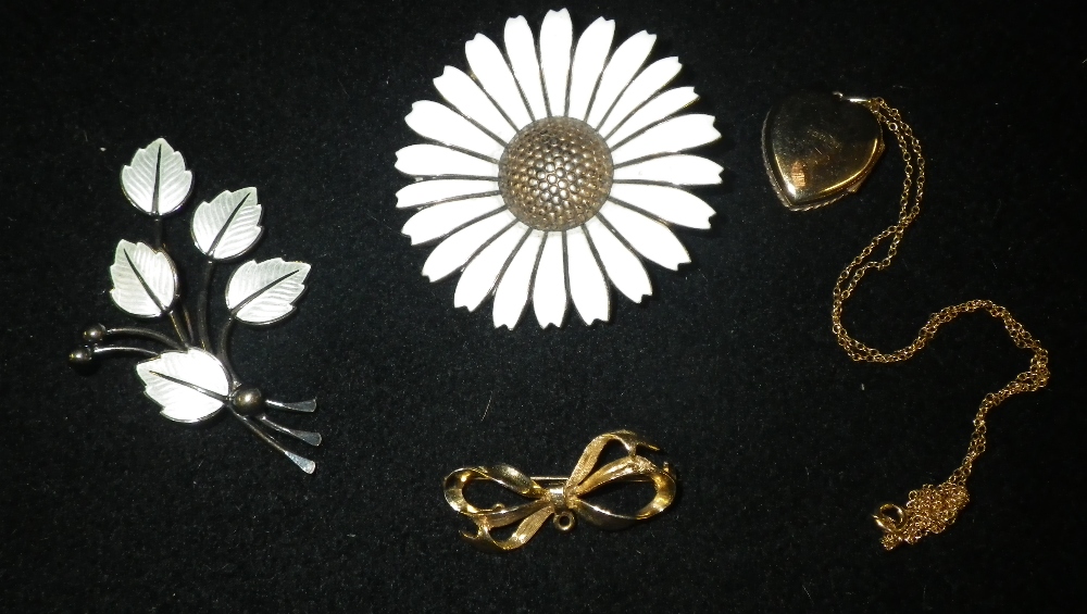 A Norwegian silver and white enamel sunflower brooch, another similar leaf brooch and two items of