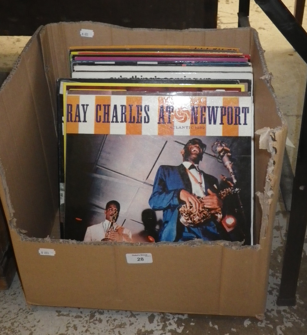 A collection of LP records, mostly jazz, including `Ray Charles at Newport`, `Louis Armstrong` and