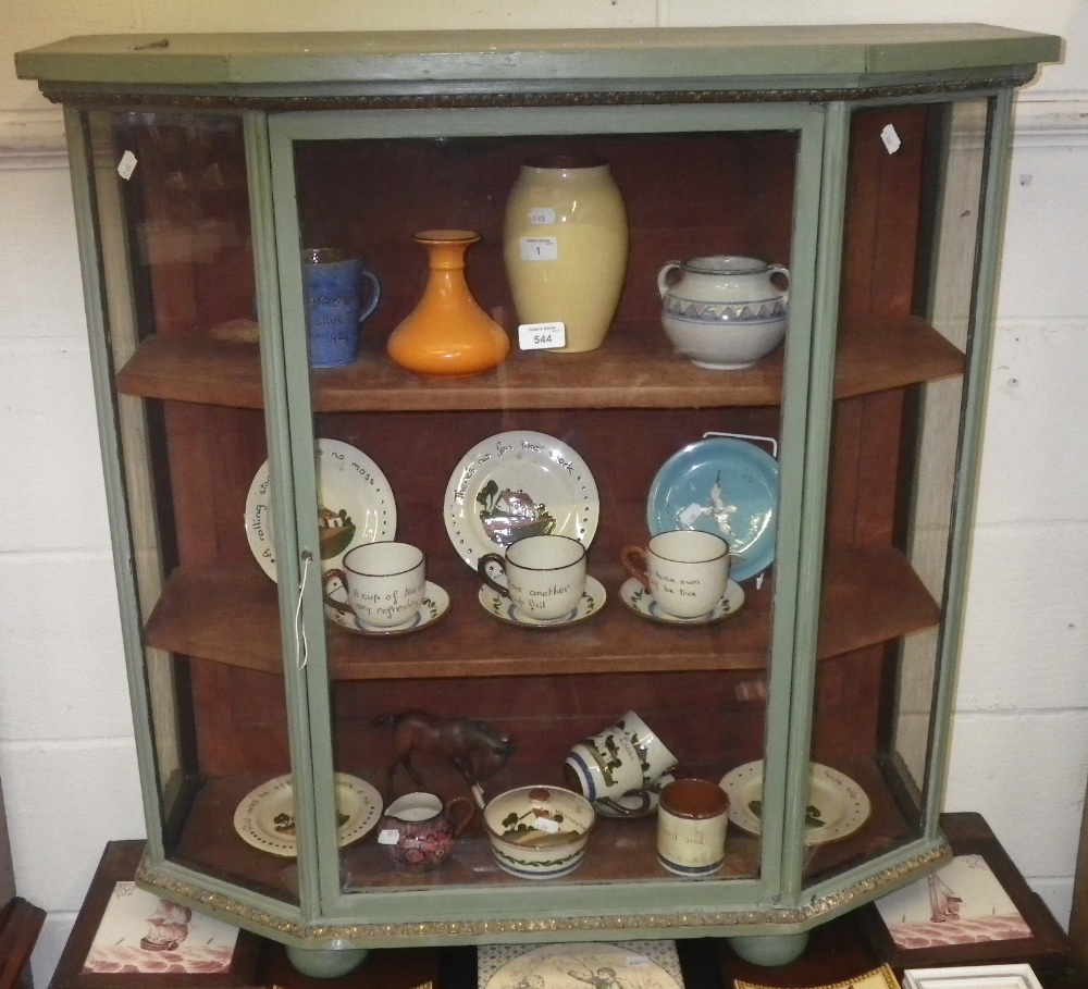 A Continental green painted glazed table cabinet with ormolu banding.