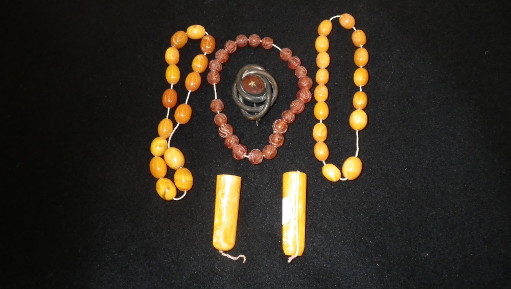 Two `Honey Amber` bead bracelets, two cheroot holders and other jewellery.