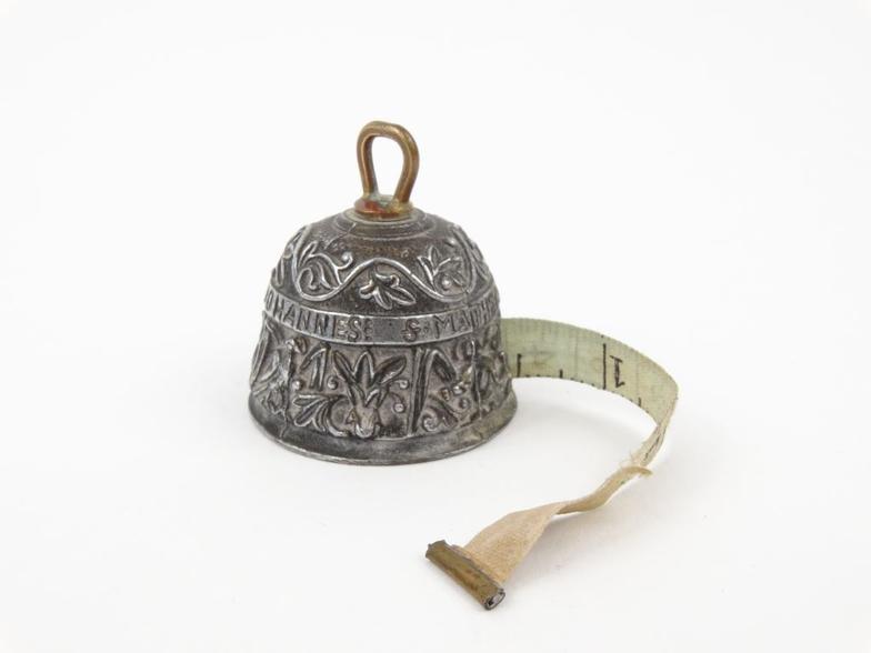 Silvered metal tape measure in the form of a table bell, stamped Geschutzt, 4cm high : FOR