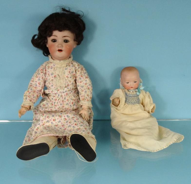 Large Simon and Halbig bisque headed doll and a small Armand Marseille bisque headed doll, the