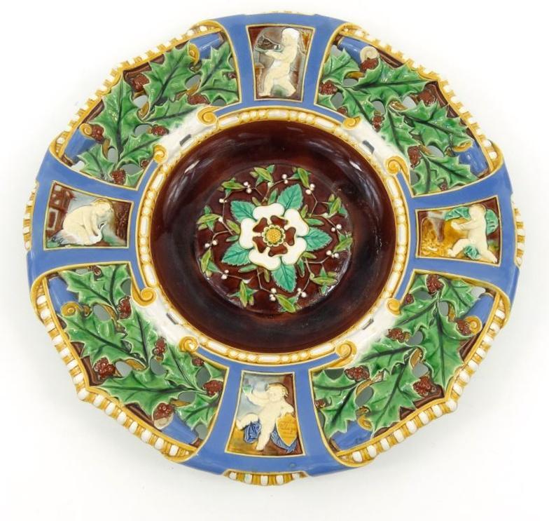 19th Century Minton Majolica Christmas charger decorated with holly and putti - one with a shield