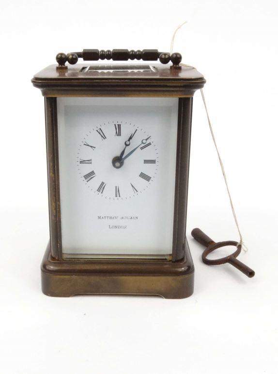 Brass carriage clock by Matthew Norman, London, with enamel dial, 11cm high excluding the handle :