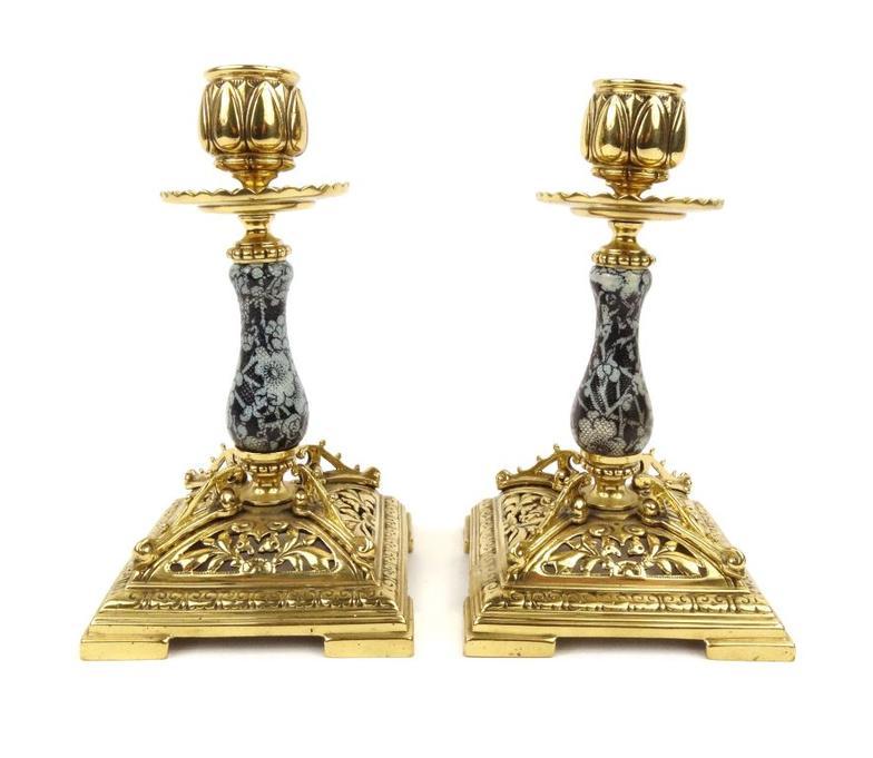 Pair of Victorian brass candlesticks with ceramic lacework style stems and pierced brass bases,