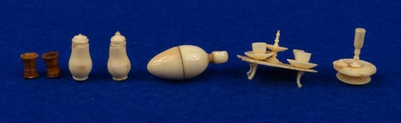 Collection of novelty ivory and bone miniature teawares and vessels, housed in a card dome topped