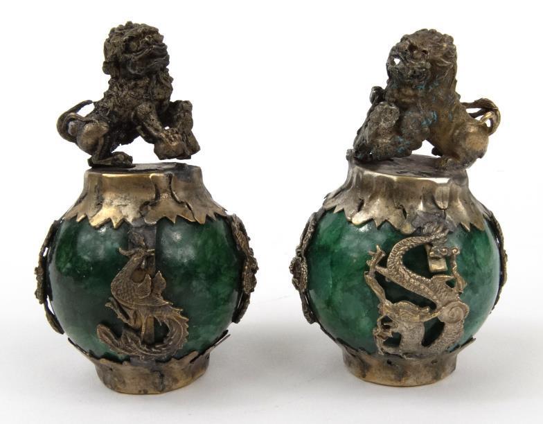 Two oriental metal mounted green stone paperweights with dog of Foo finials and dragon mounts, 7cm