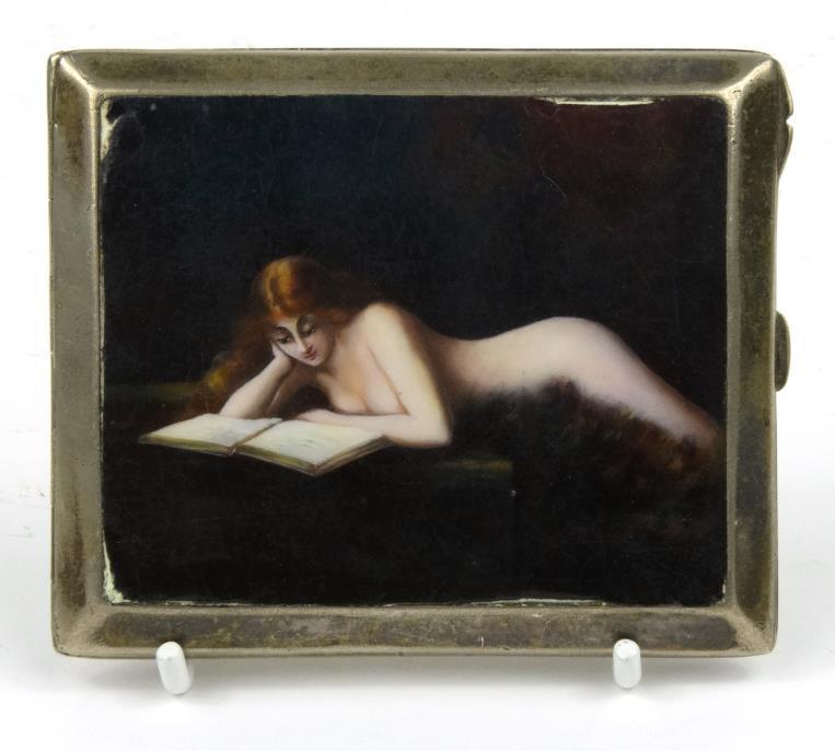 Rectangular silver coloured metal cigarette case enamelled with a view of a nude female reading a