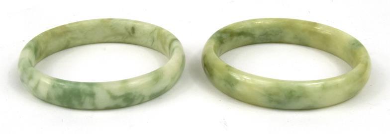 Two Chinese green hardstone bangles, 7cm diameter : For condition reports, please visit www.
