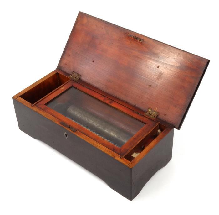 Cylinder music box, the ebonised wood case opening to reveal a mechanical action movement stamped