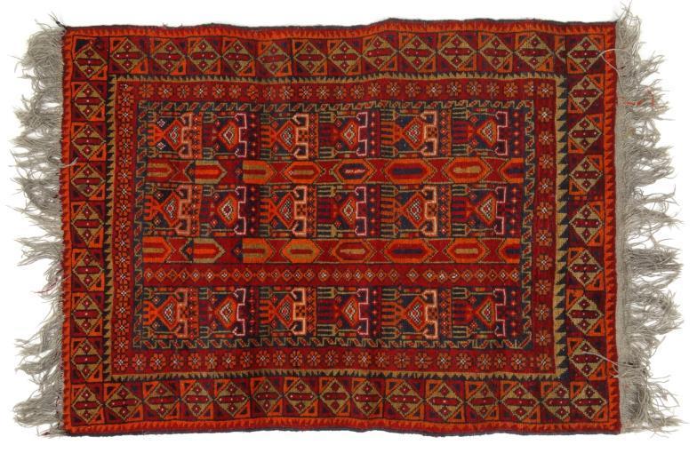 Middle Eastern rug decorated with geometric motifs onto a predominantly red ground, 120cm x 90cm :