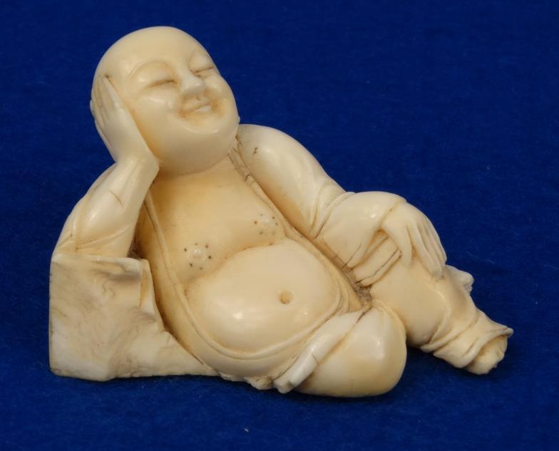 Chinese carved ivory figure of a recumbent Buddha, 5cm in length : For condition reports, please