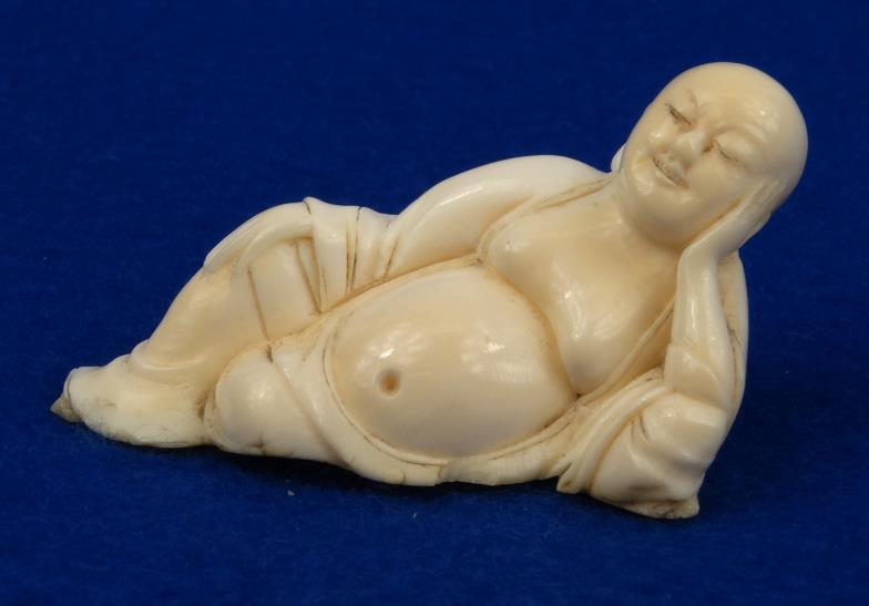 Chinese carved ivory figure of a recumbent Buddha, 6cm in length : For condition reports, please