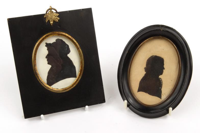 Two 19th century oval portrait silhouettes - male and female, each in an ebonised wood frame - one