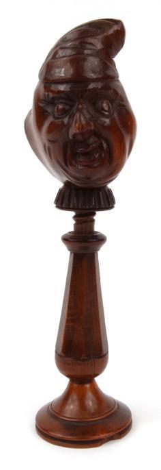 Treen folk art nutcracker with carved double faced terminal, 18cm high : For condition reports,