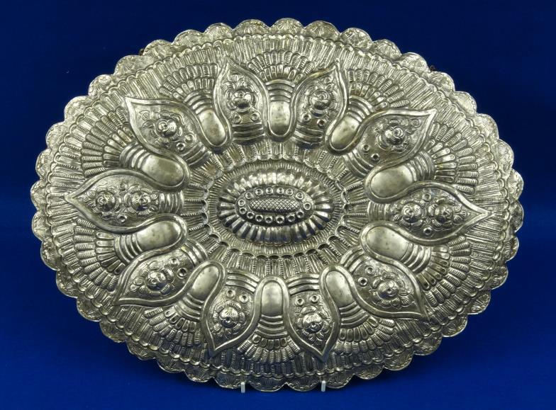 Middle Eastern oval modesty mirror with embossed silver coloured metal frame, stamped `900` to the