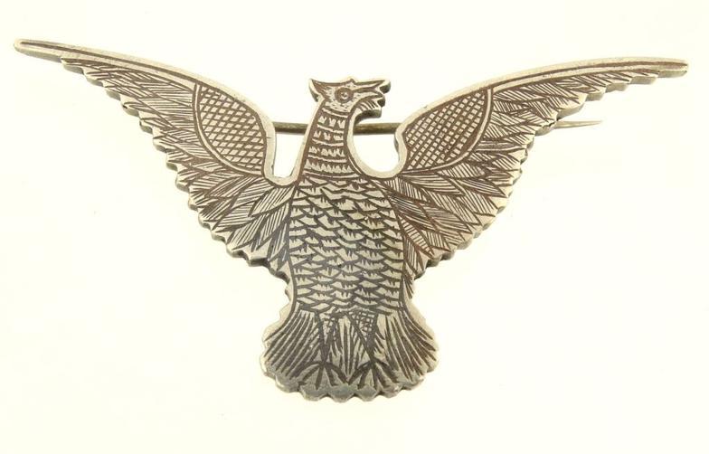 Silver coloured metal eagle brooch with engraved decoration to the reverse 6cm in length