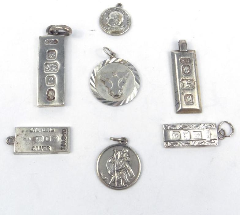 Four silver ingot pendants and three circular silver pendants approximate weight 48.6g : FOR