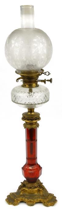 Victorian oil lamp with cut glass reservoir cut red glass stem and ornate metal base fitted with a