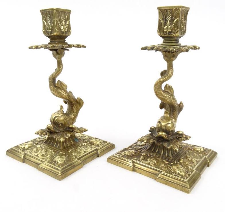 Pair of 19th century square based gilt brass candlesticks with dolphin design stems and mask faces